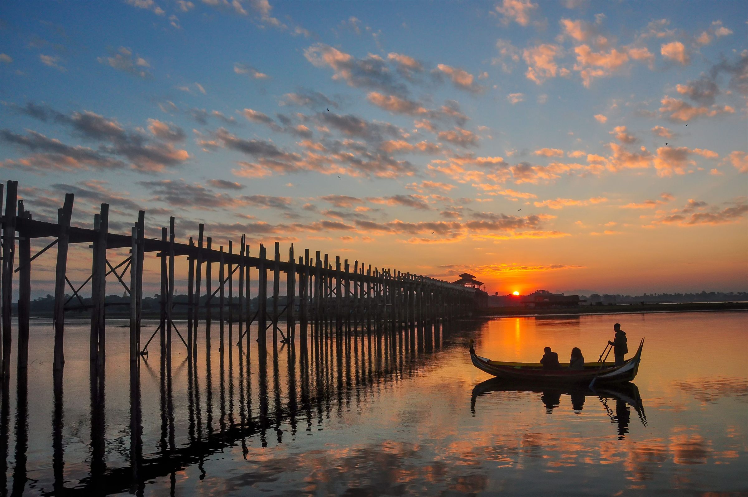 Dawn over U Bein Bridge with a boat on Taungthaman Lake, Amarapura, Mandalay Region
