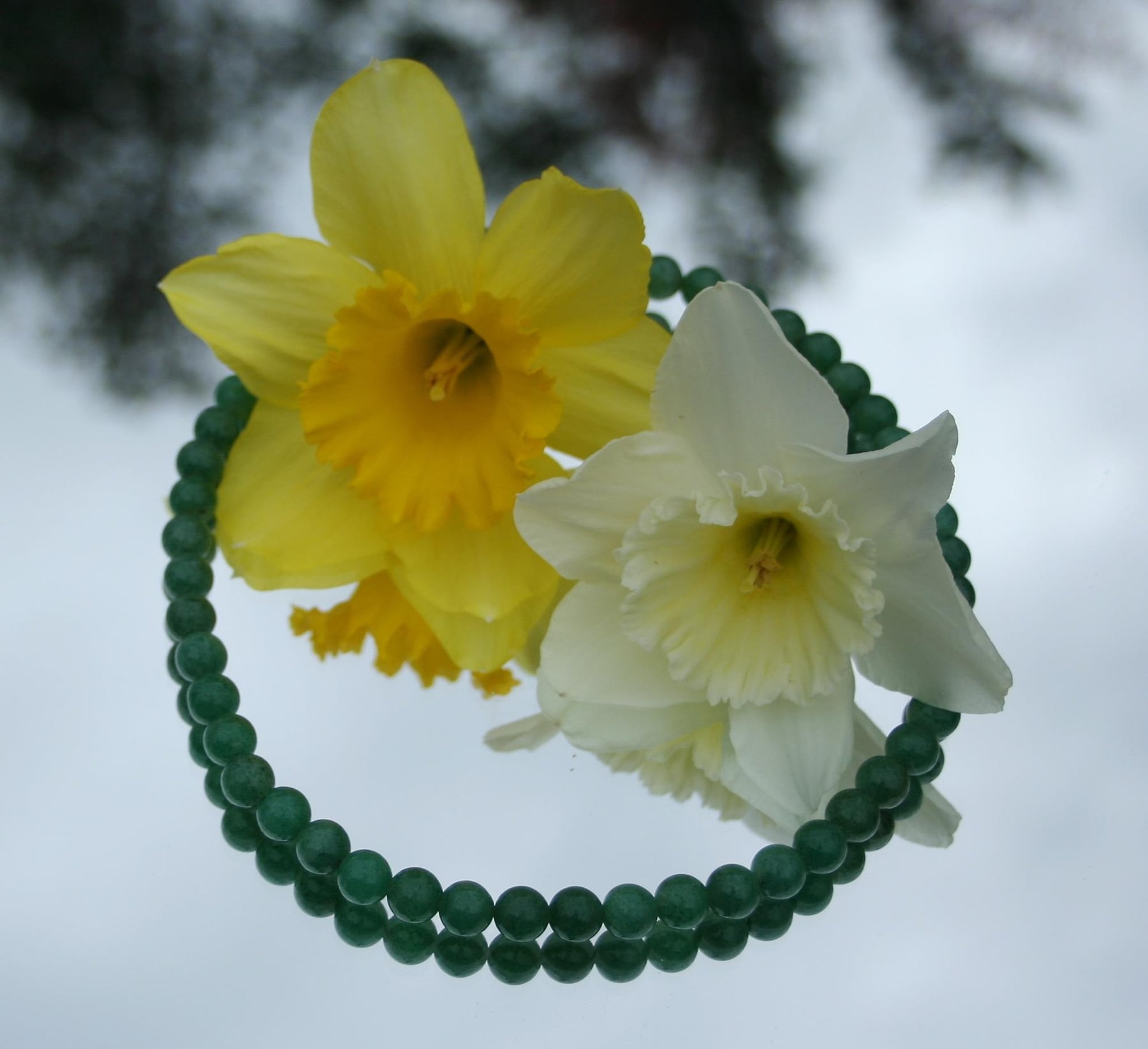 A strand of round, deep-green jade beads, the kind used in jadeite bead necklaces like the Hutton-Mdivani.