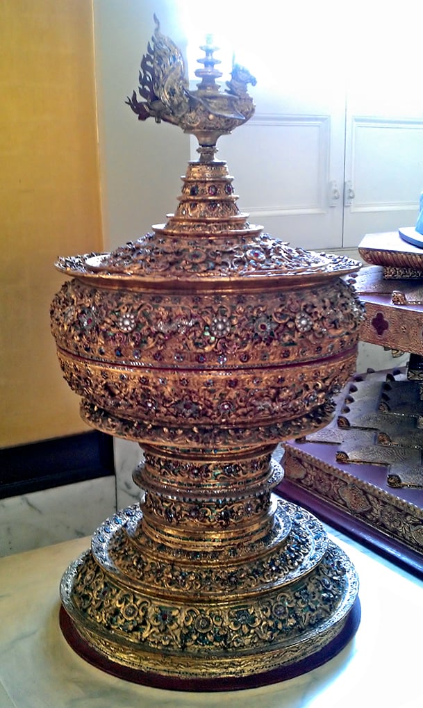 An ornate gilded hsun-ok offering vessel with a tall, pointed, spired lid.